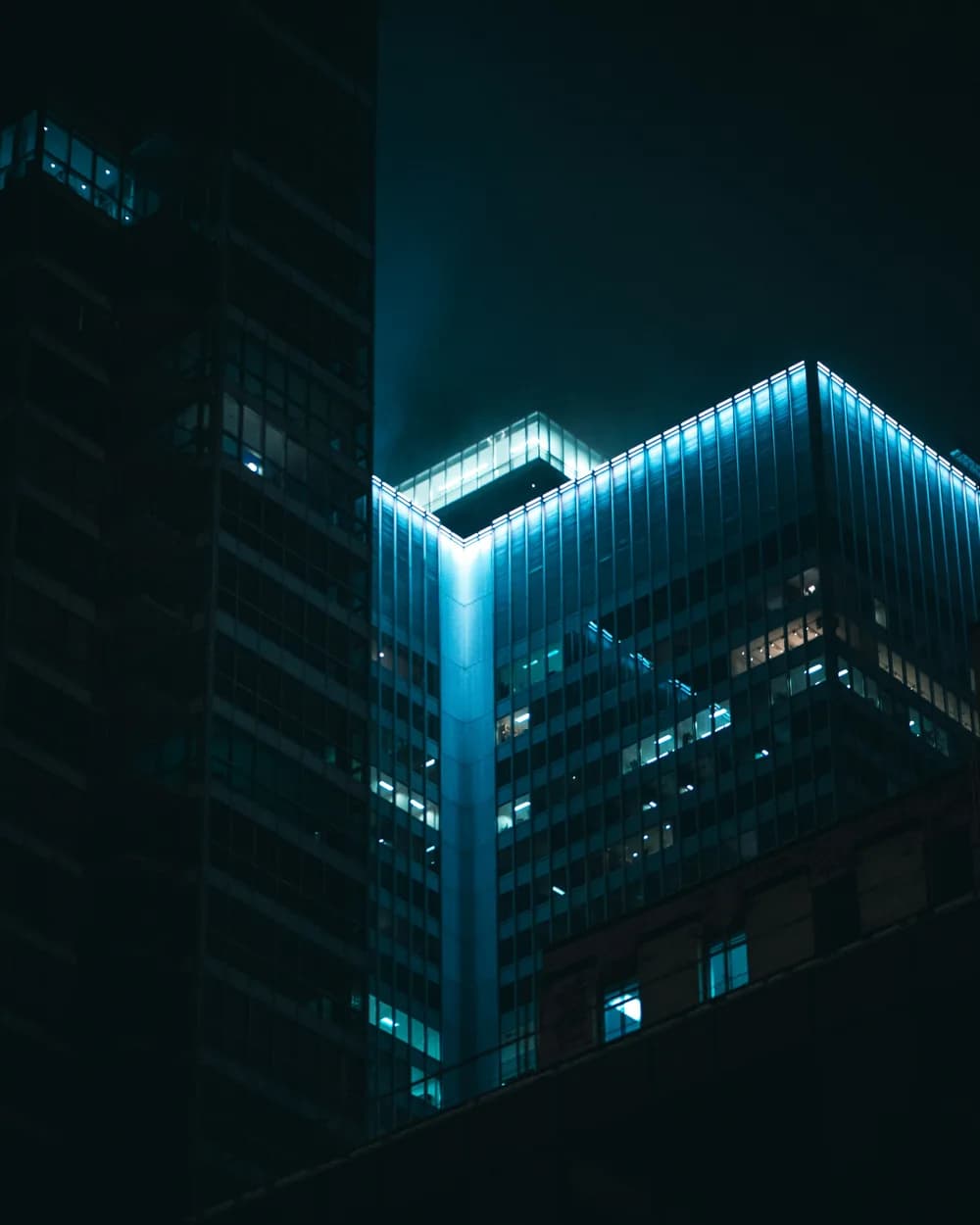 Teal-lit architectural facade at night